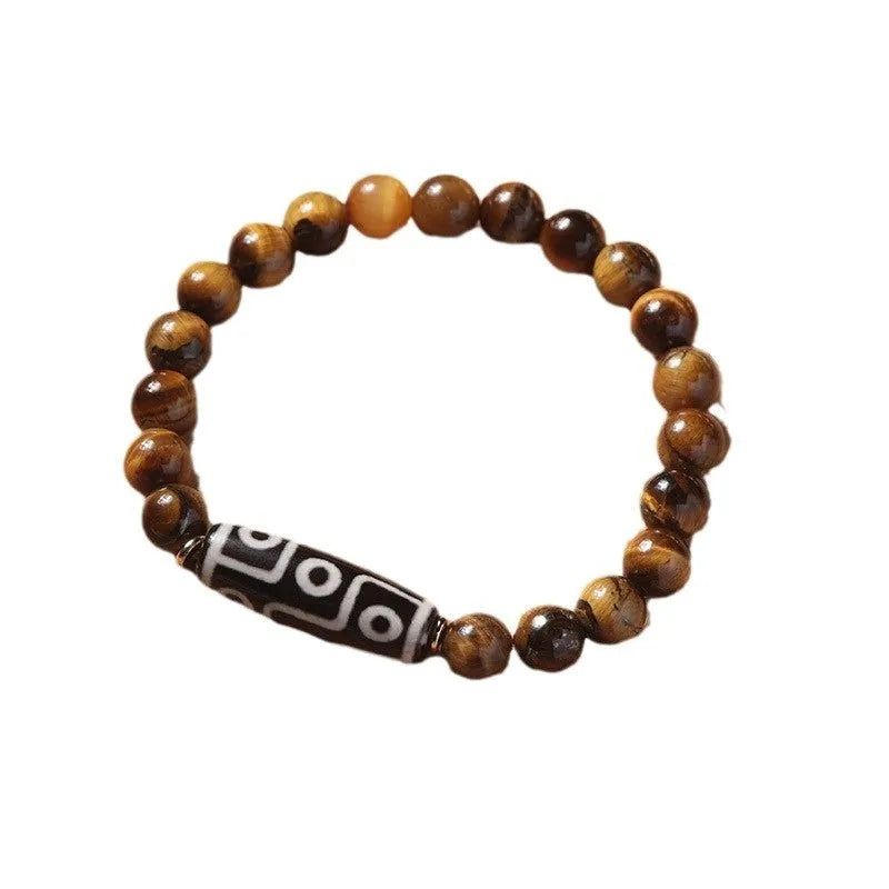 Tigereye stone bead bracelet with a single central Dzi bead featuring a circle design.