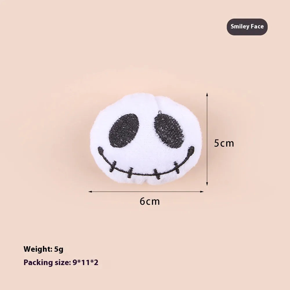 Small colourful plush cat teaser toy with candy, eyes and skull attachments