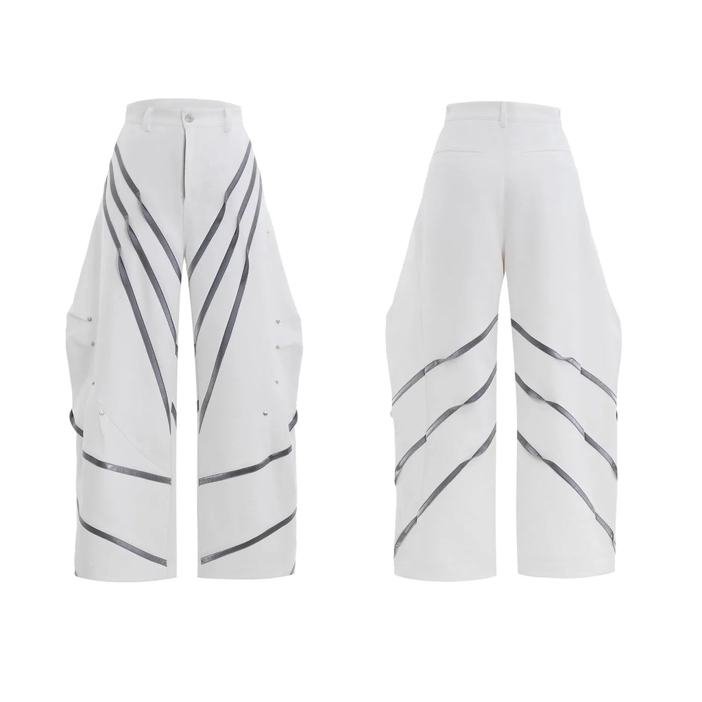 Men's black trousers with silver metal striped rivet details and pleated front.