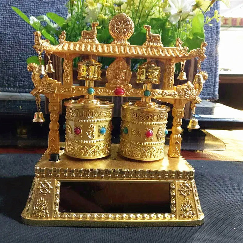 Traditional Chinese style alloy prayer wheel car decoration on a dashboard.