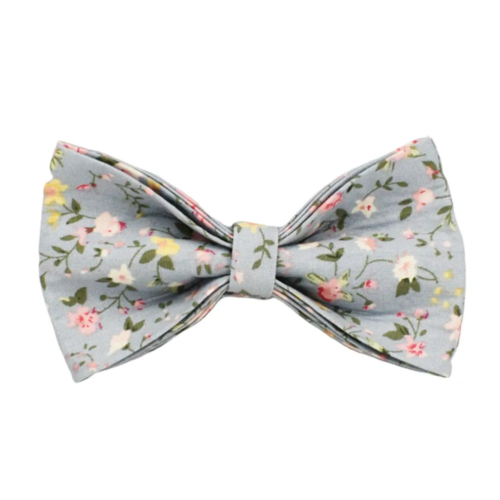 Blue floral patterned dog collar with matching accessories including leash, bow, vest, and poop bag