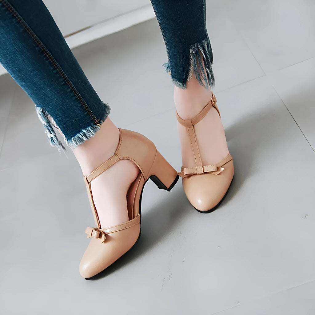 Women's apricot coloured sandals with a chunky 6.5cm heel, bow tie decoration, and a single buckle strap.