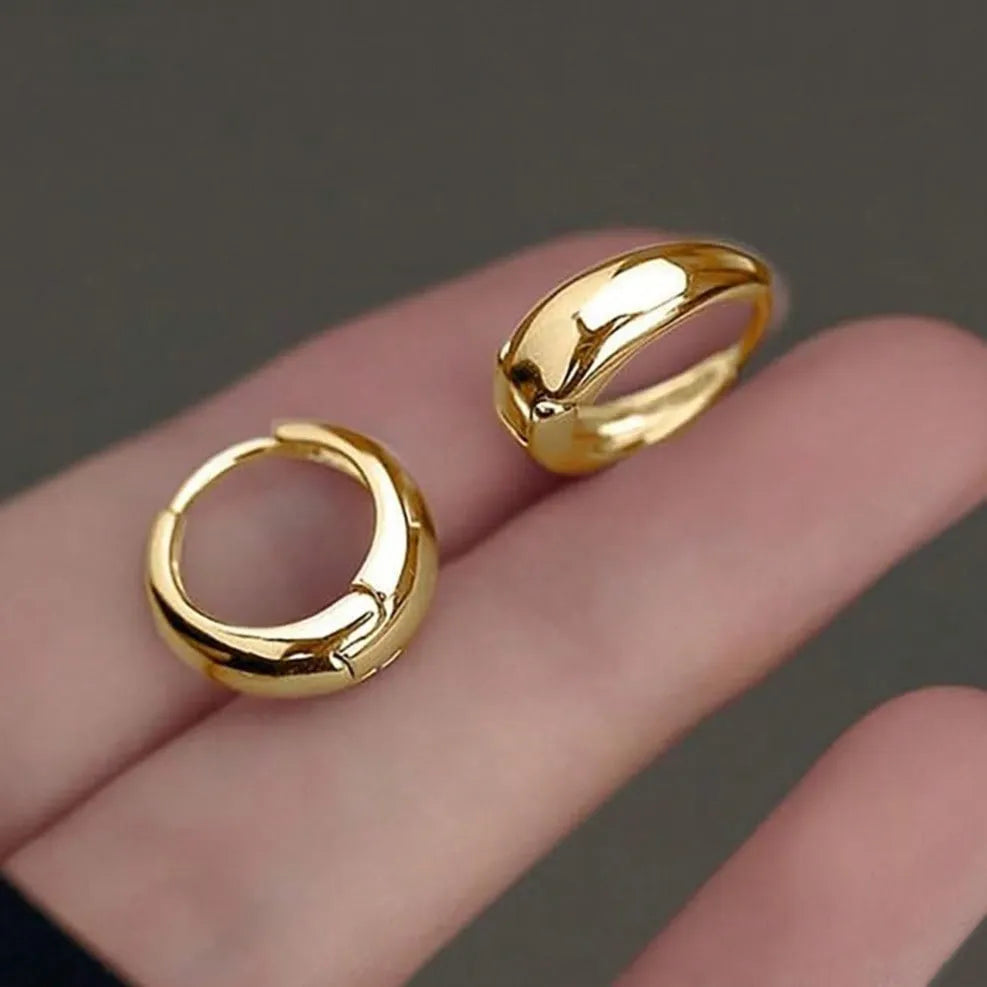 Gold electroplated copper geometric ring earrings for women, shown as a single pair or three-pair set.