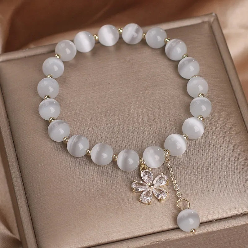 White Cat's Eye stone bracelet with flower tassel and morganite safety buckle.