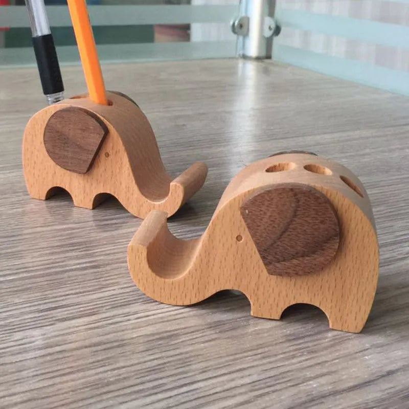 Solid beech wood mobile phone stand with a decorative resin animal ornament and a coin slot.