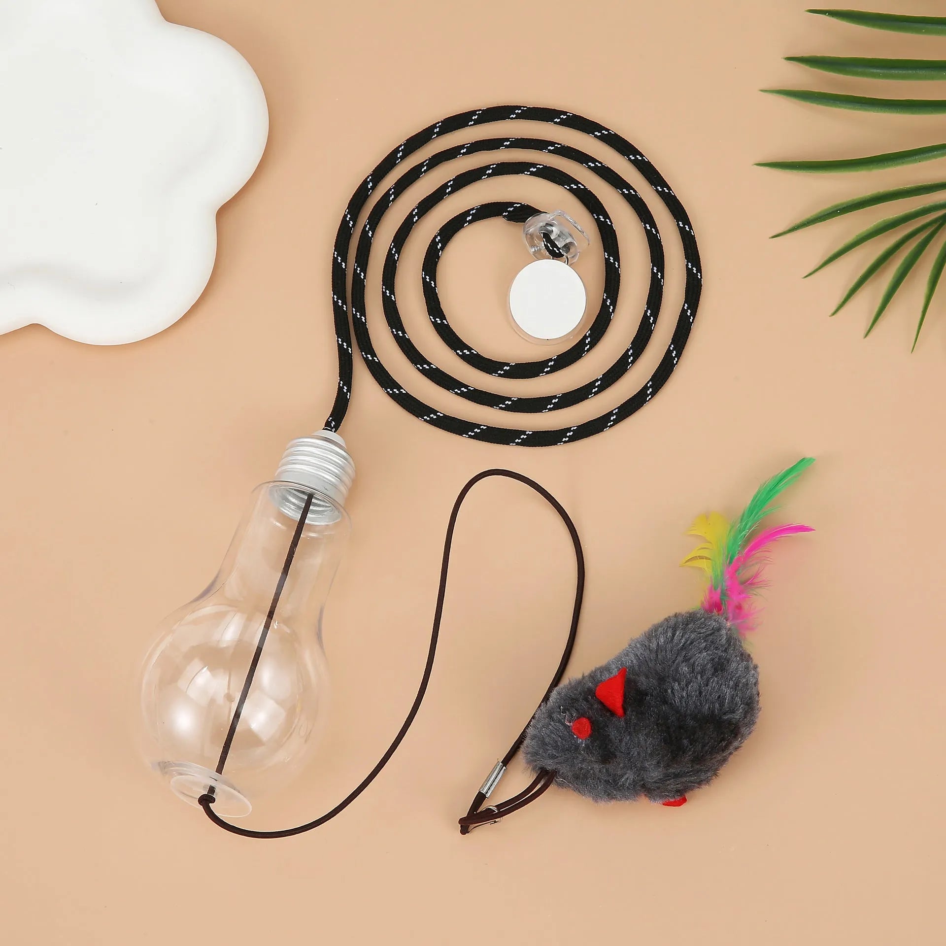 Grey and yellow retractable cat teaser toy hanging on door frame with treat bulb and dangling mouse