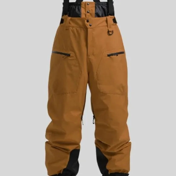 Man wearing black waterproof ski trousers with an adjustable strap, on a ski slope.