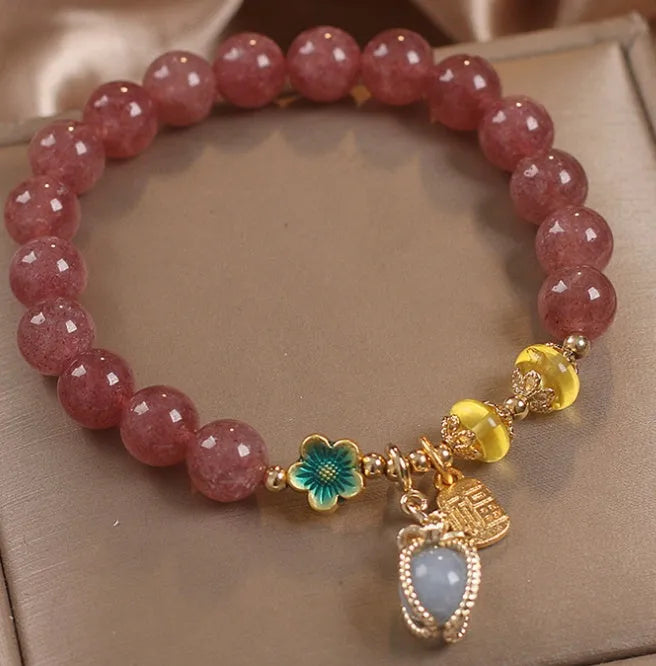 Red women's bracelet with strawberry quartz beads, alloy metal, and rhinestone detailing
