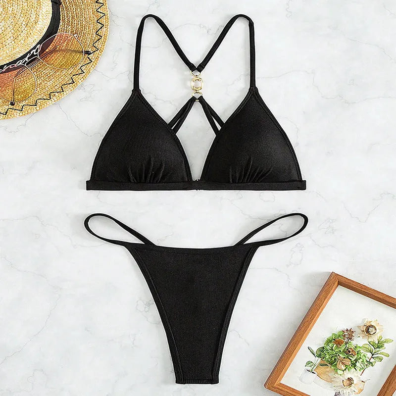 Women's black hollow backless bikini set with triangle top and matching pants on hanger