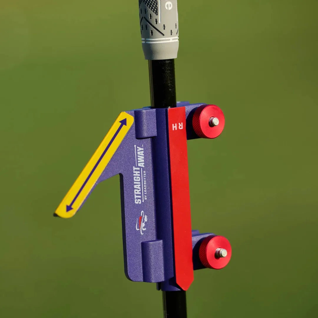 Plastic golf swing plane simulator training aid on a green surface.
