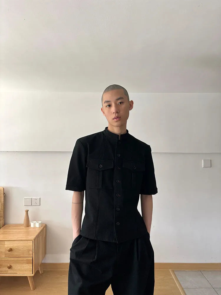 Black handmade Red Eye half sleeve hunting shirt with a shirt collar on a hanger.