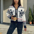 White women's zip-up cardigan with a jacquard contrast colour stripe pattern and a lapel collar.