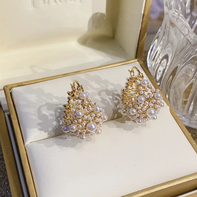 Gold copper flower basket earrings with small rice-shaped beads and pearl inlay detail