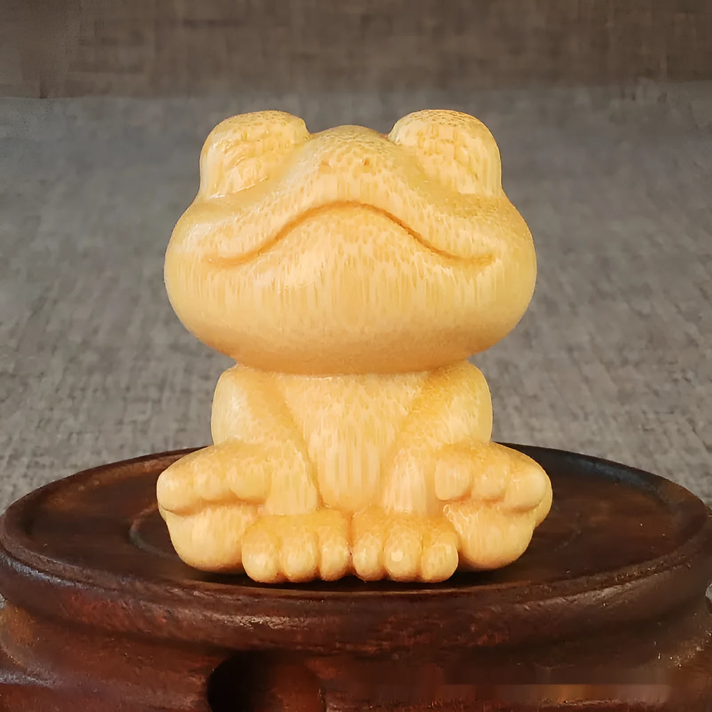 Solid bamboo smiling frog carving ornament next to a 120ml oil glove brush.