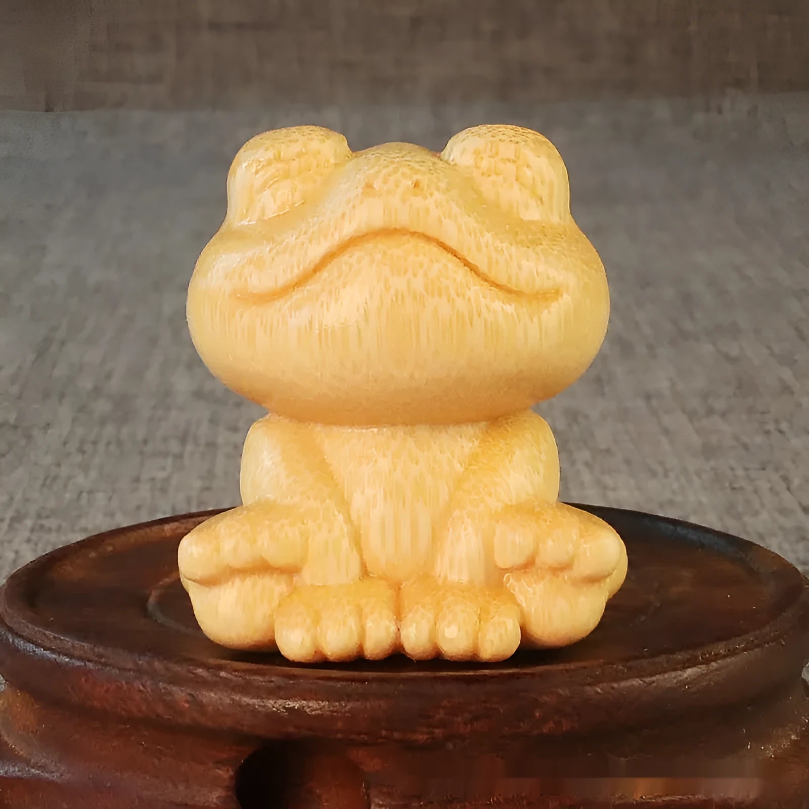 Solid bamboo smiling frog carving ornament next to a 120ml oil glove brush.