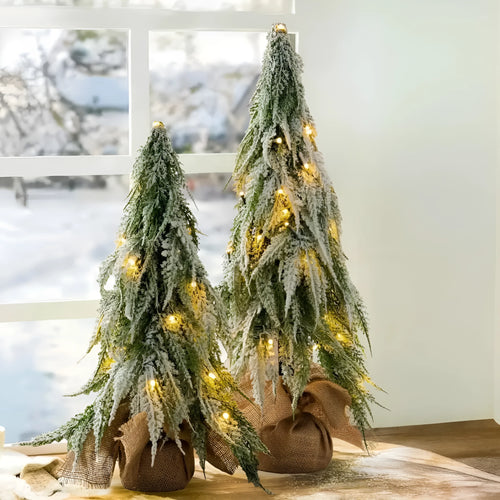 24-inch artificial Christmas tree with snow spray finish and integrated lights on desktop