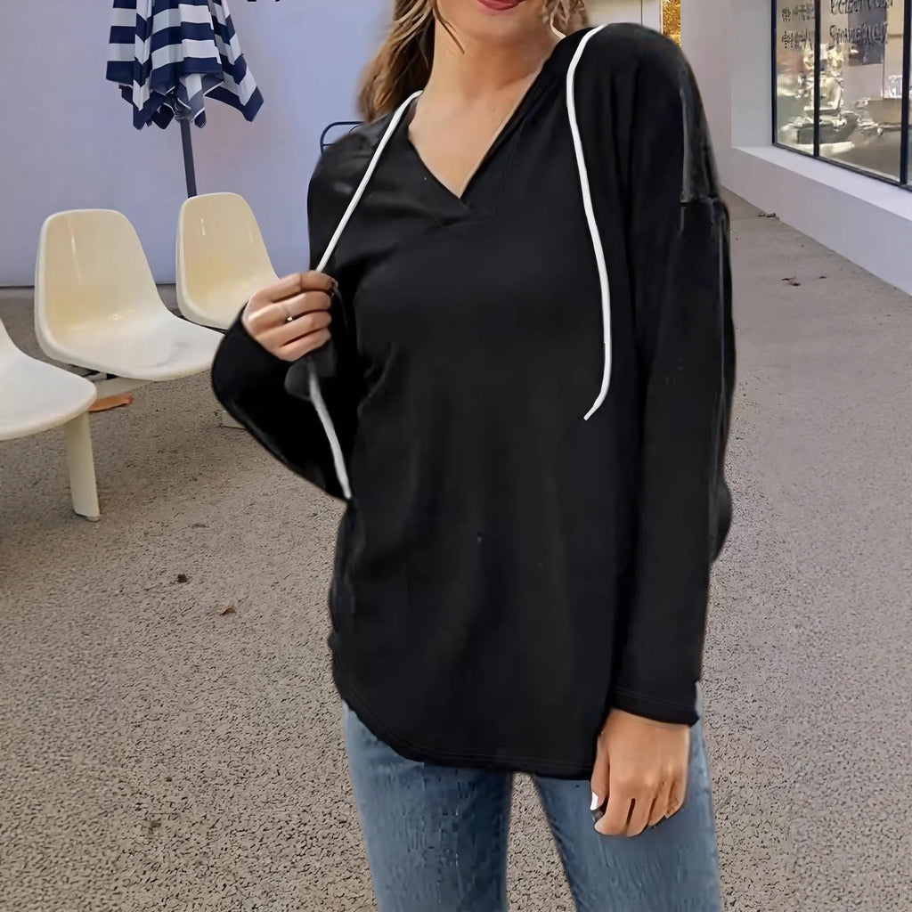 A red women's V-neck sweatshirt with an attached hood, shown in a loose, medium-length fit.