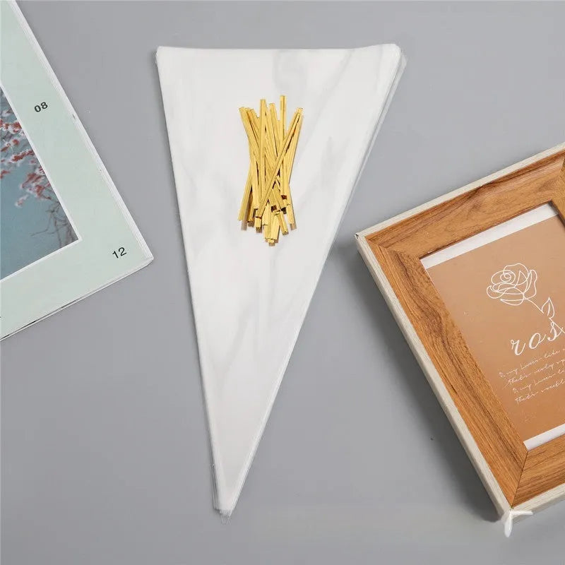 Clear triangle-shaped plastic packaging bag with a twisted wire tie closure.