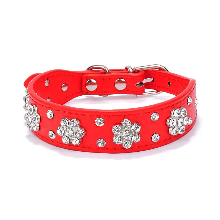 Soft black PU leather dog collar with a sparkling rhinestone flower pattern and silver metal studs, showing the adjustable eyelets and D-ring.