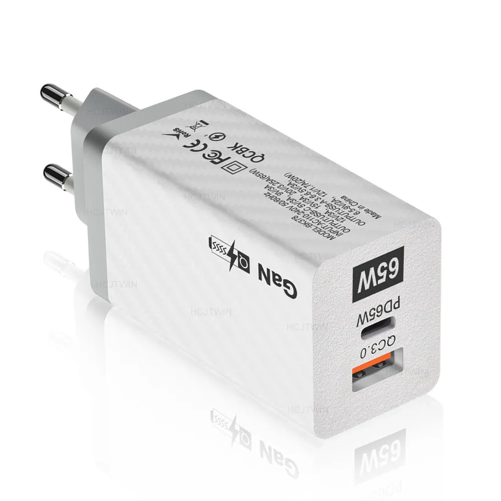 White GaN 65W universal laptop charger with USB PD port showing compact dimensions