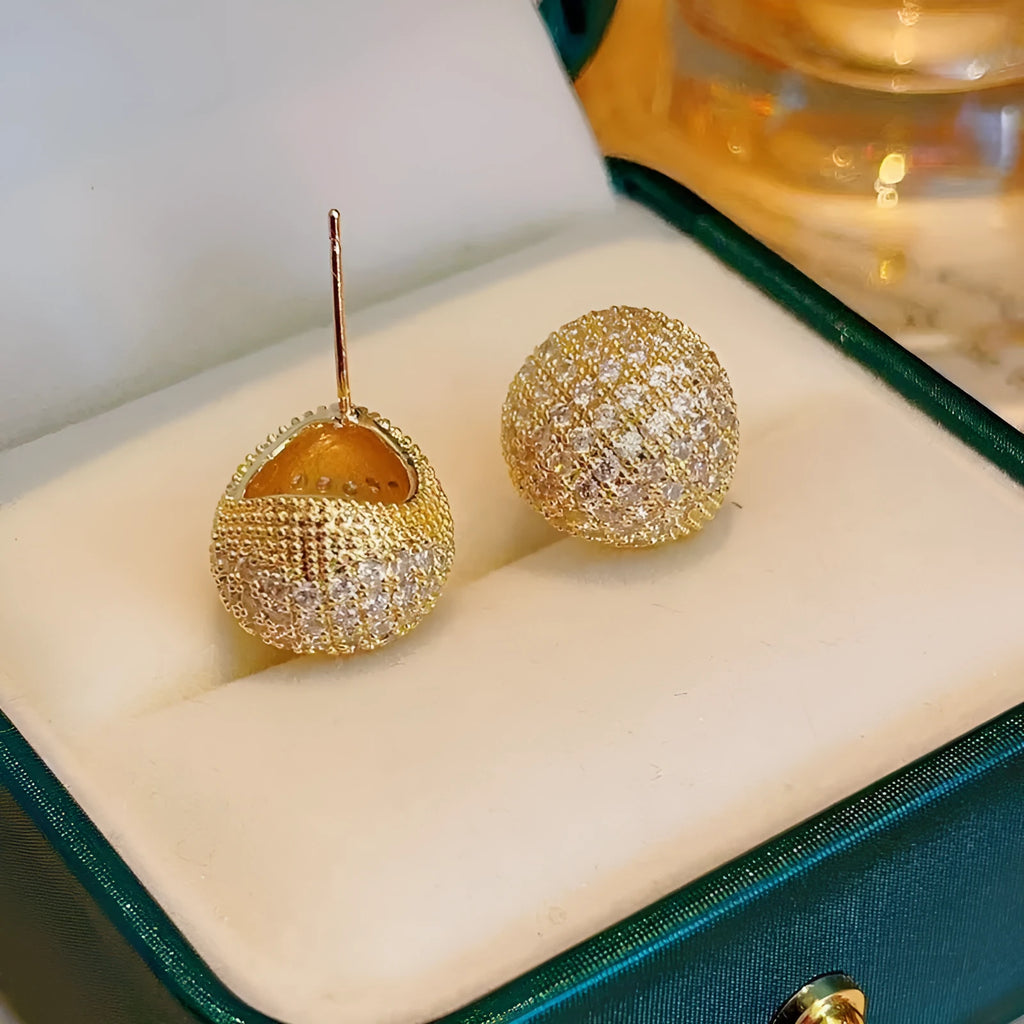 Gold geometric drop earrings with diamond patterning and sphere elements