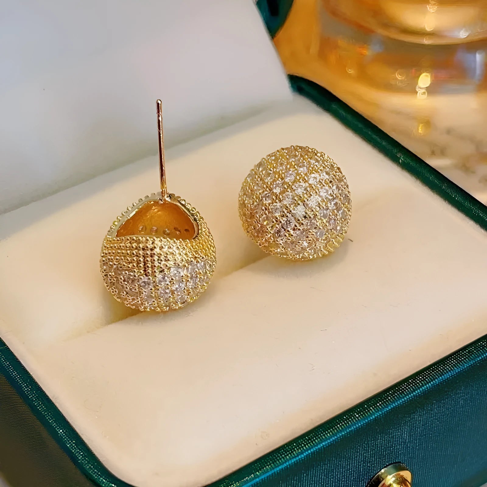 Gold geometric drop earrings with diamond patterning and sphere elements