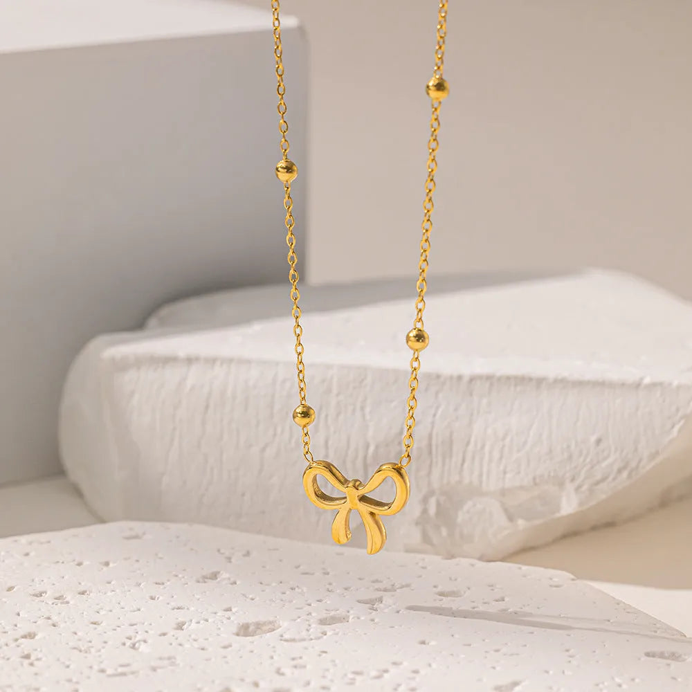 Gold electroplated bow necklace for women with titanium steel chain and adjustable length