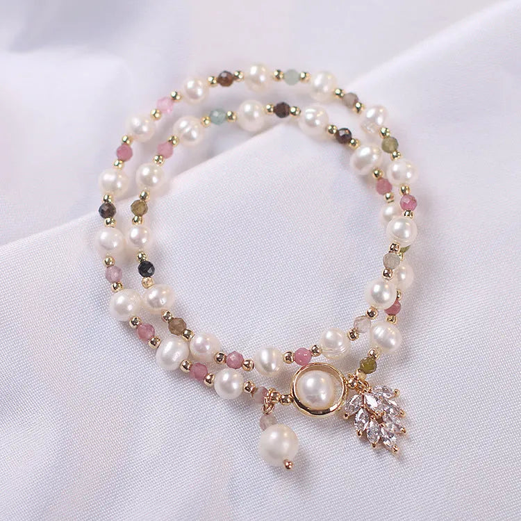 Double-layer strawberry quartz bracelet with lucky cat charm and red cat's eye flowers on adjustable fastening