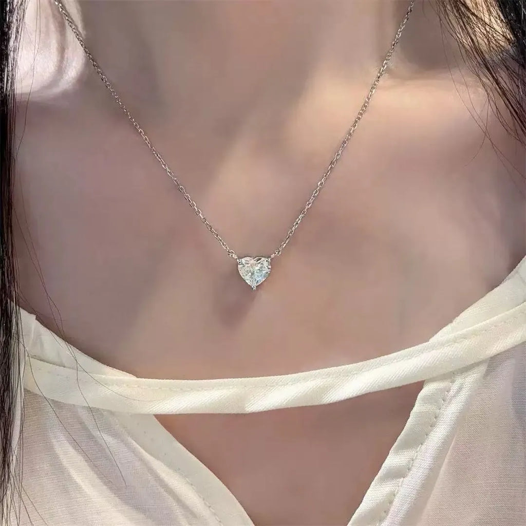 Women's simple copper necklace with silver heart-shaped pendant on display