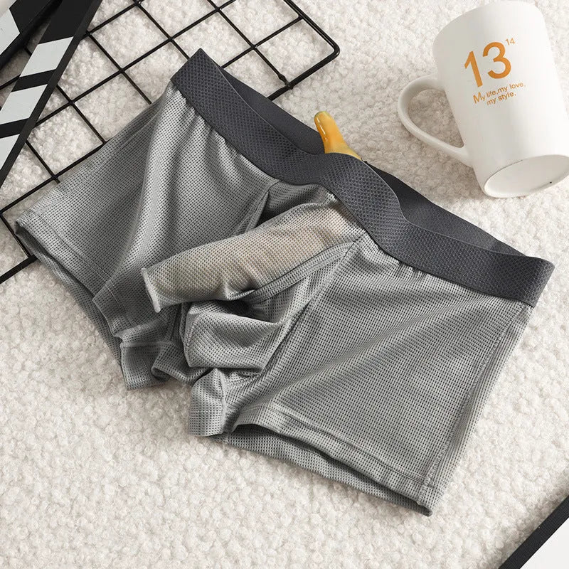 Men's solid colour Ice Silk nylon boxer underwear with mesh breathable fabric in black, grey, or white.