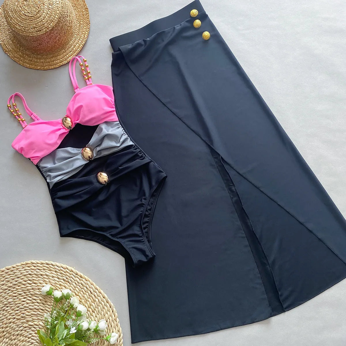 Women's brown one-piece swimsuit with a matching beige skirt laid flat.