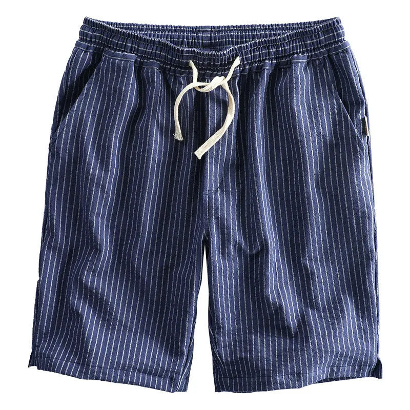 Man wearing black and white striped cotton casual shorts with a loose straight fit.