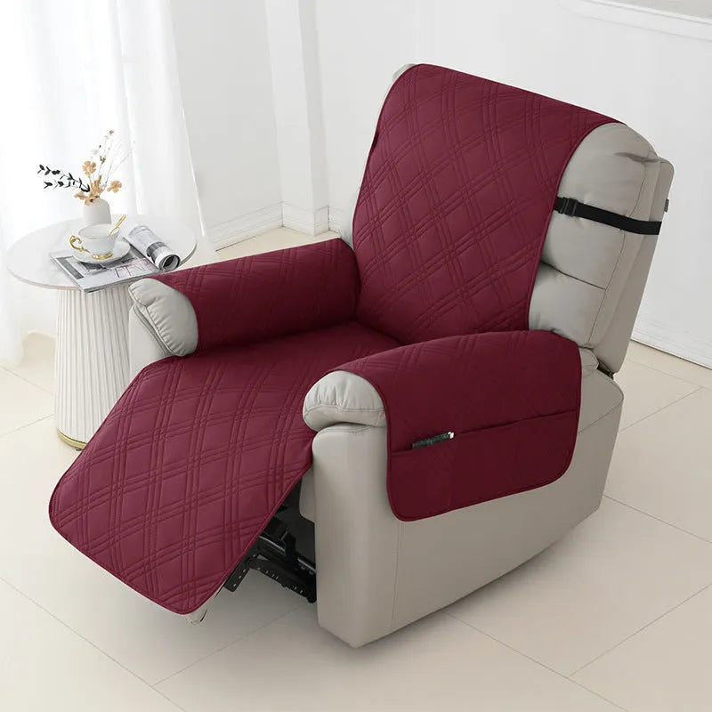 Quilted burgundy waterproof sofa cover stretched over a small single-seat massage chair cushion.