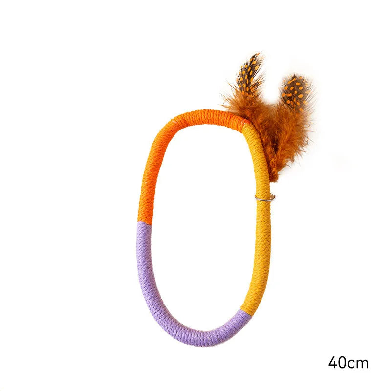 Green circular cotton rope cat toy with white feathers and catnip for indoor cats