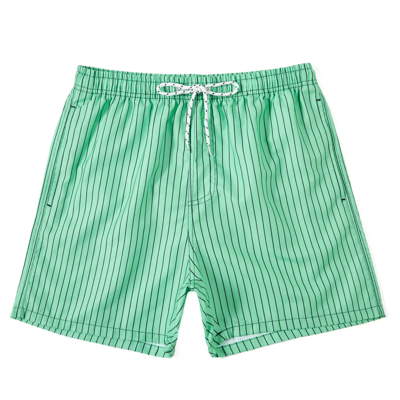 Man wearing grey striped polyester beach shorts with a straight leg opening, on a beach.