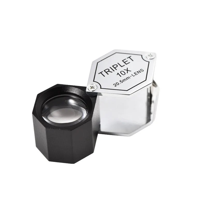 Handheld metal jeweller's loupe with optical glass lens for stamp and coin identification.