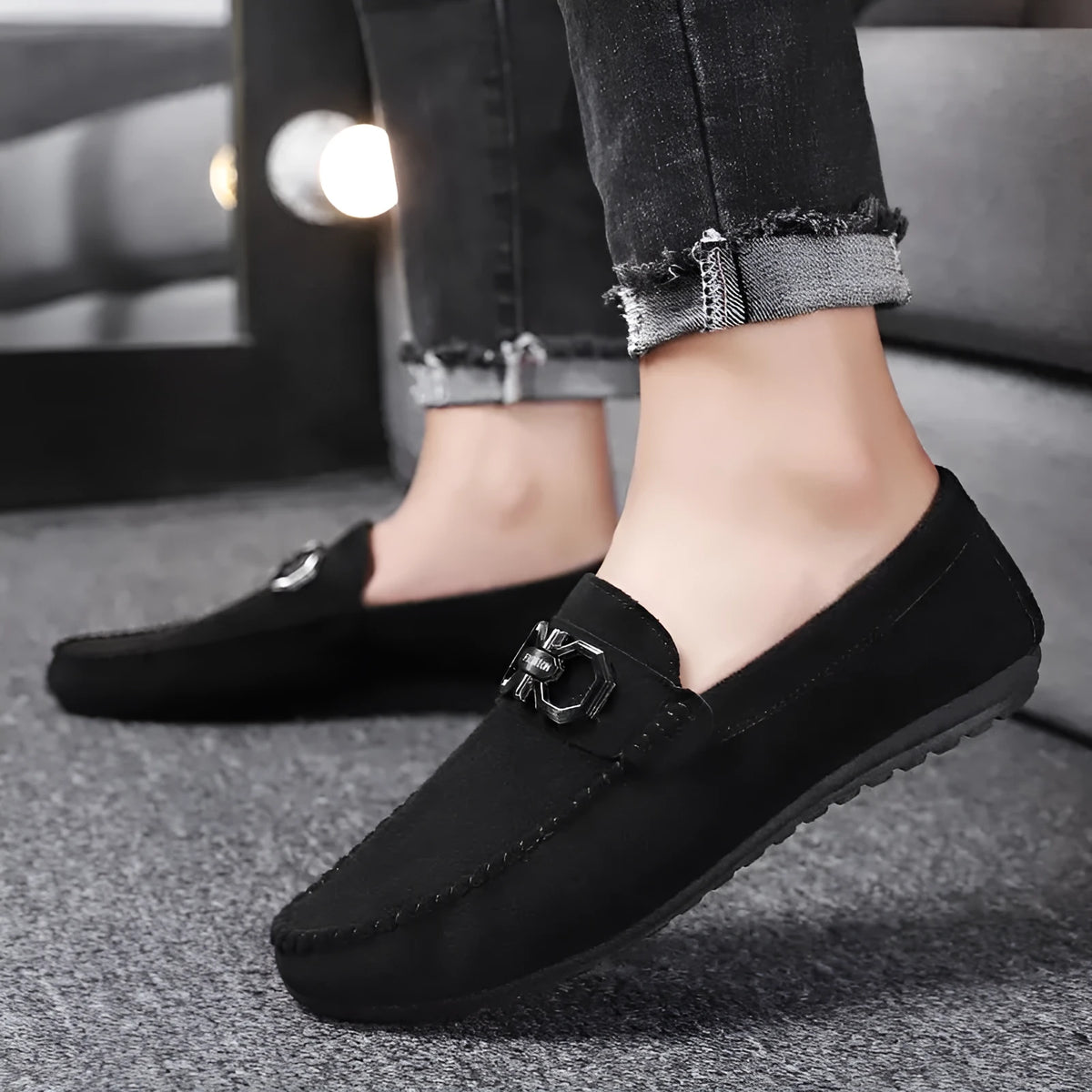 Men's black and grey suede and leather casual sneakers with rubber sole on a plain background.