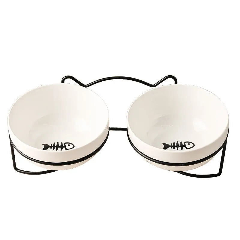 White ceramic cat bowl with decorative iron frame in cat footprints pattern