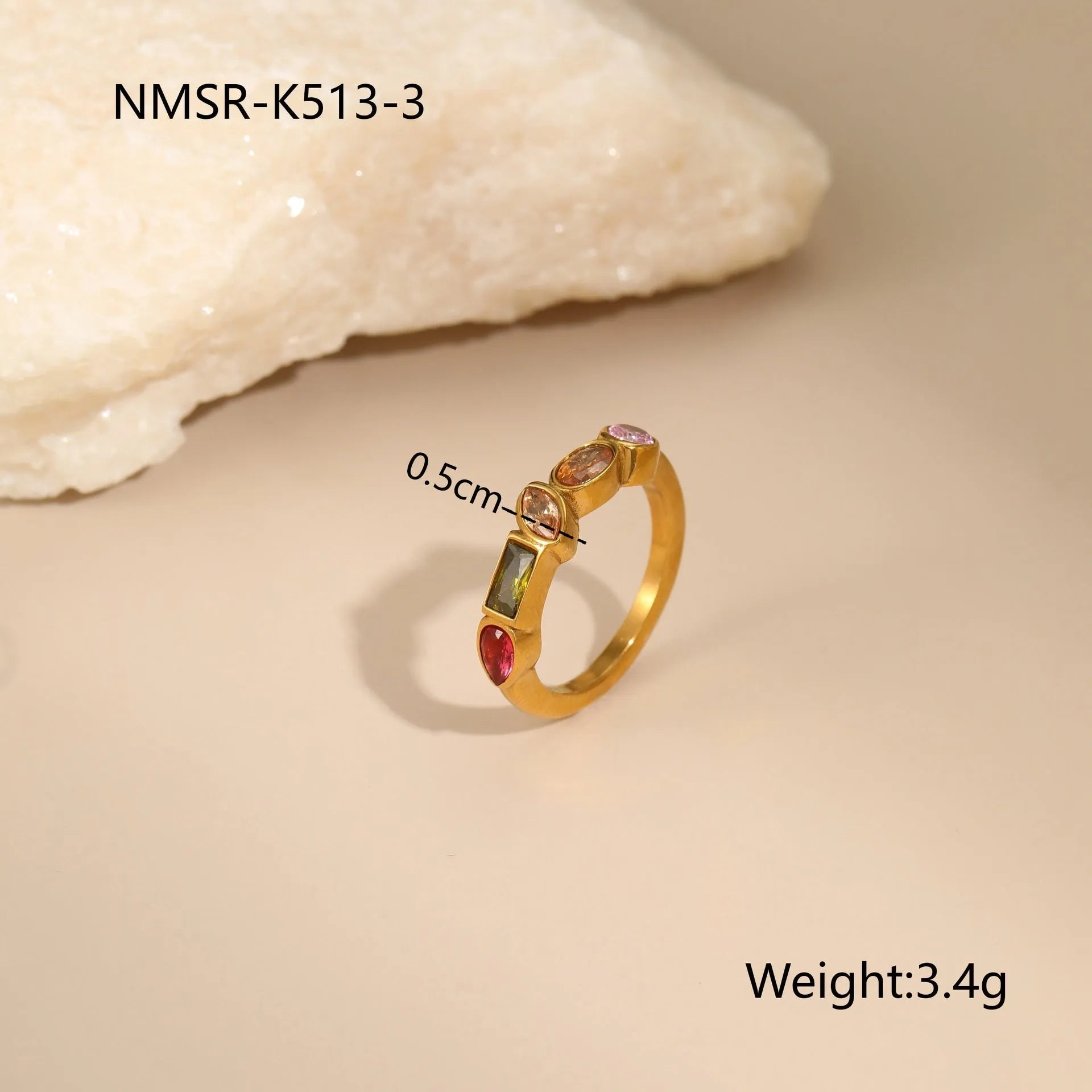 Geometric gold plated jewellery set on display showing drop necklace, U shape necklace, ring, and earrings with zircon accents.