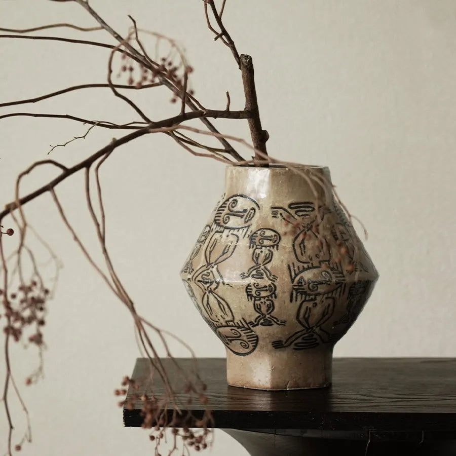 Hand-painted ceramic vase with tribal totem patterns in cylindrical shape
