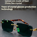 Dark green frameless crystal sunglasses with protective case and cleaning cloth
