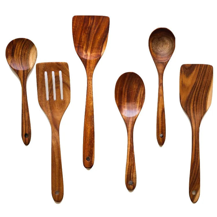 Seven wooden cooking utensils arranged together showing different shapes and sizes