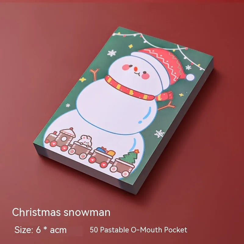 Christmas sticky notes book with cartoon designs of Santa, snowman, elf, gift, house, sled, crystal ball, and bear