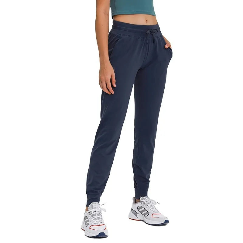 Women's high waist yoga pants with drawstring waistband in quick-drying fabric, available in multiple colours