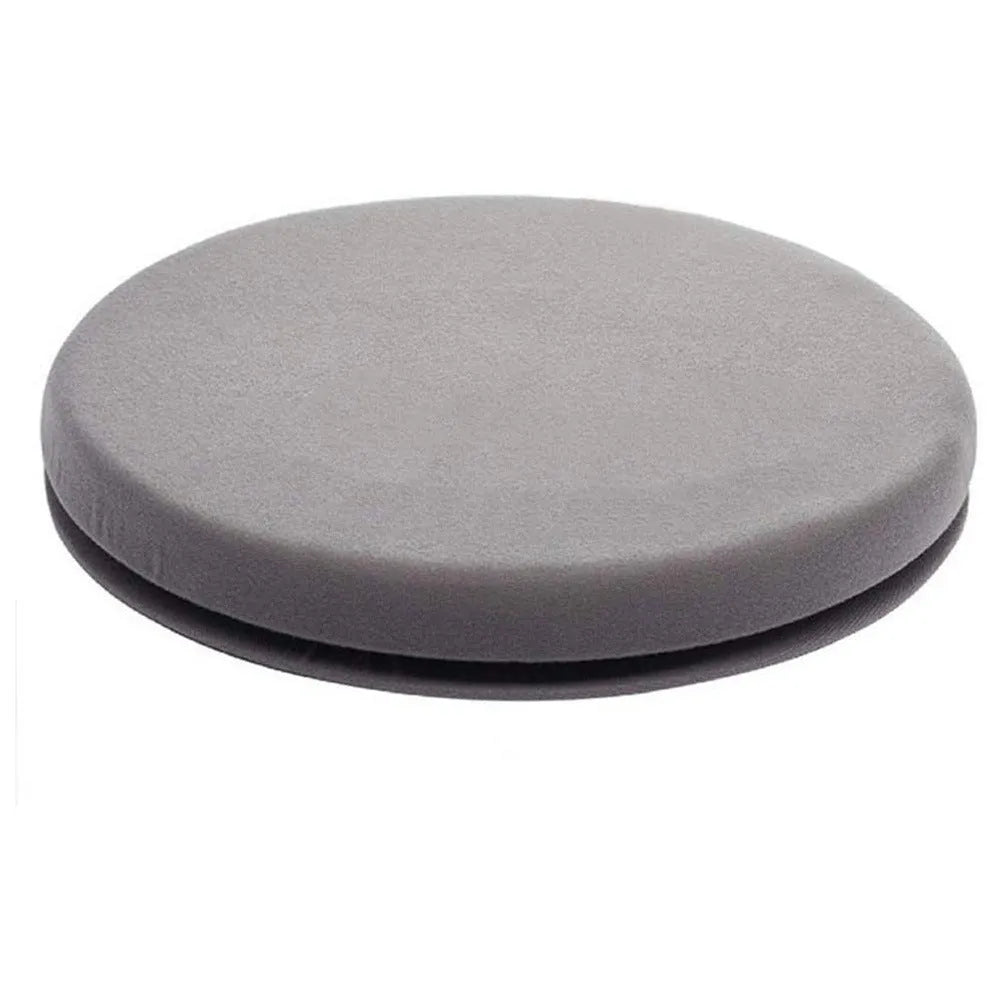 Round, grey rotating car seat cushion for elderly passenger assistance on a car seat.