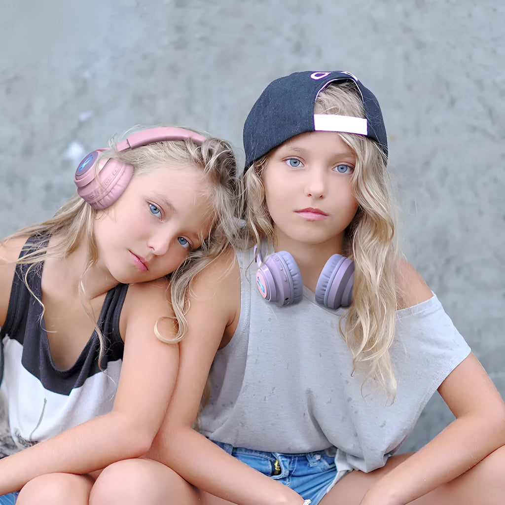Children's wireless headphones with RGB lights in bunny pink colour showing power display and microphone