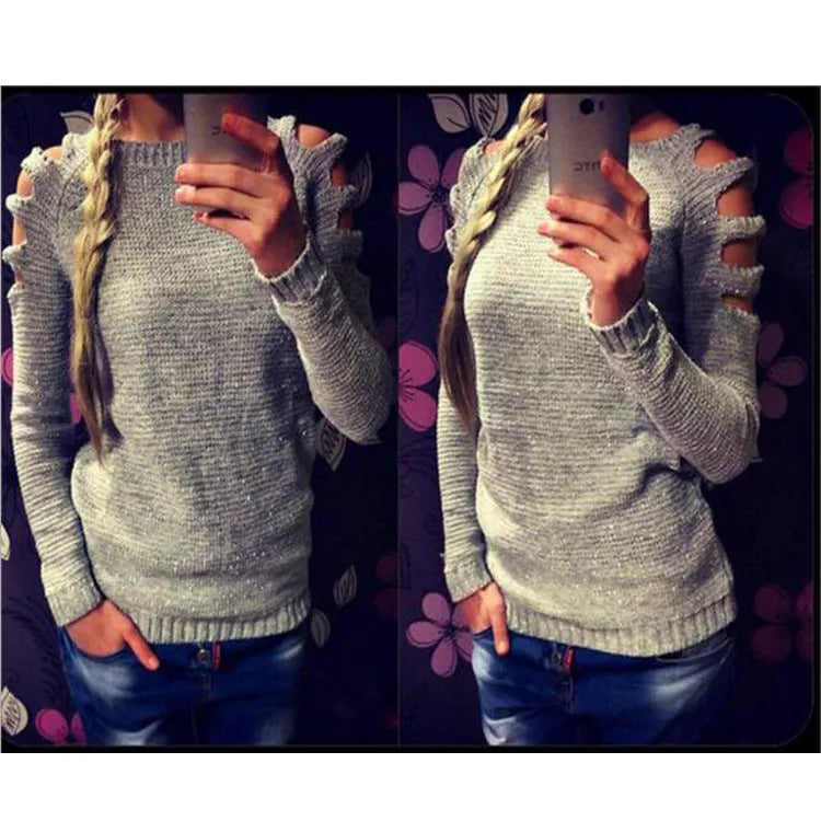 Women's grey hollow out knitted pullover top with round neck and long sleeves laid flat.