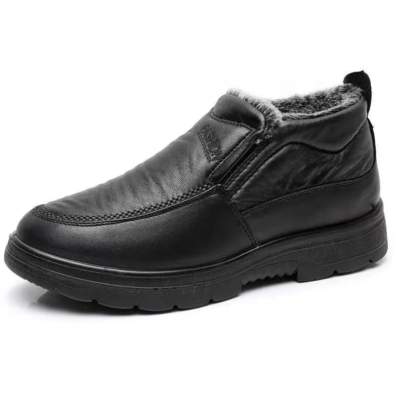 Men's black fleece-lined slip-on winter shoes with a rubber sole on a grey background.