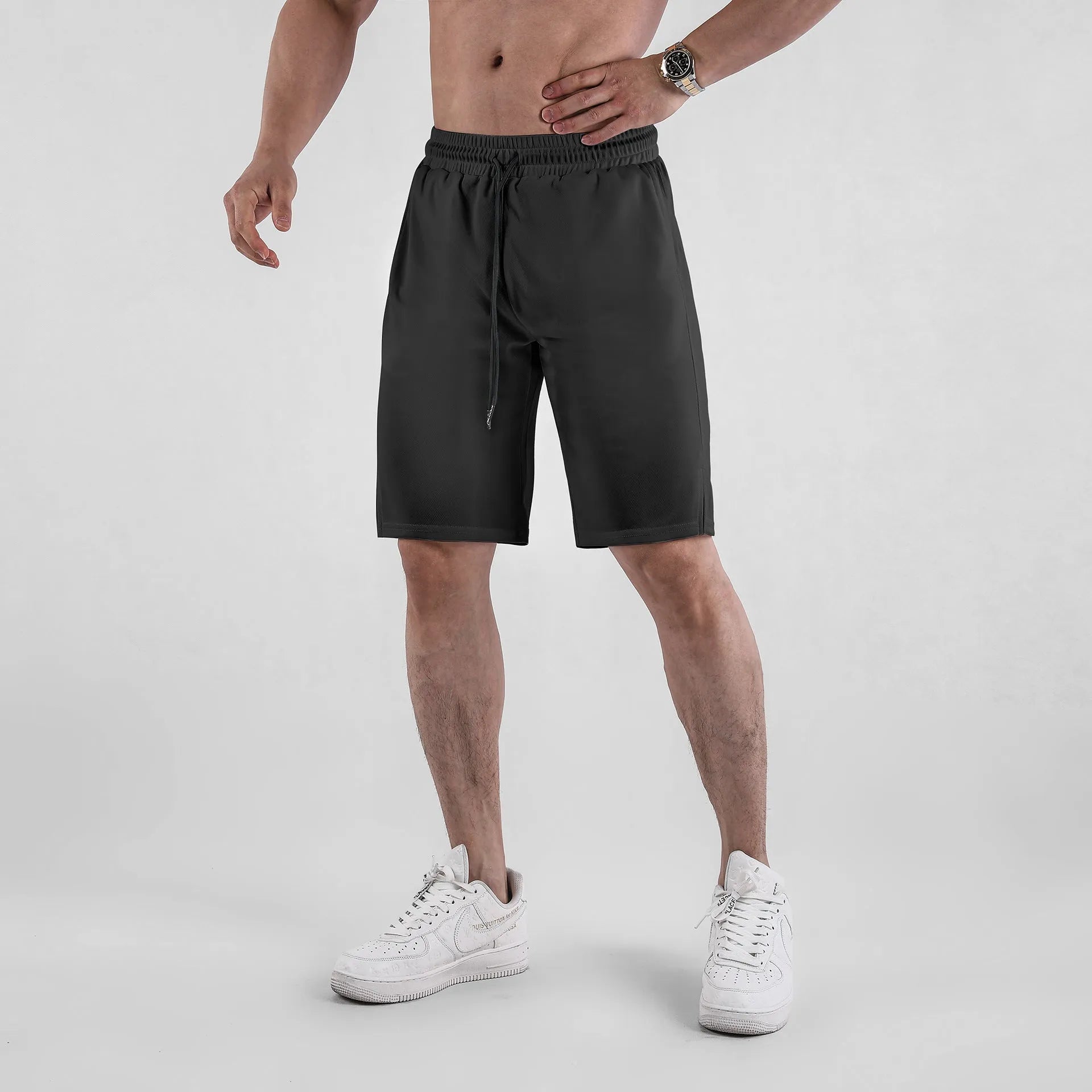 Men's black mesh capri shorts with elastic waistband and loose fit design