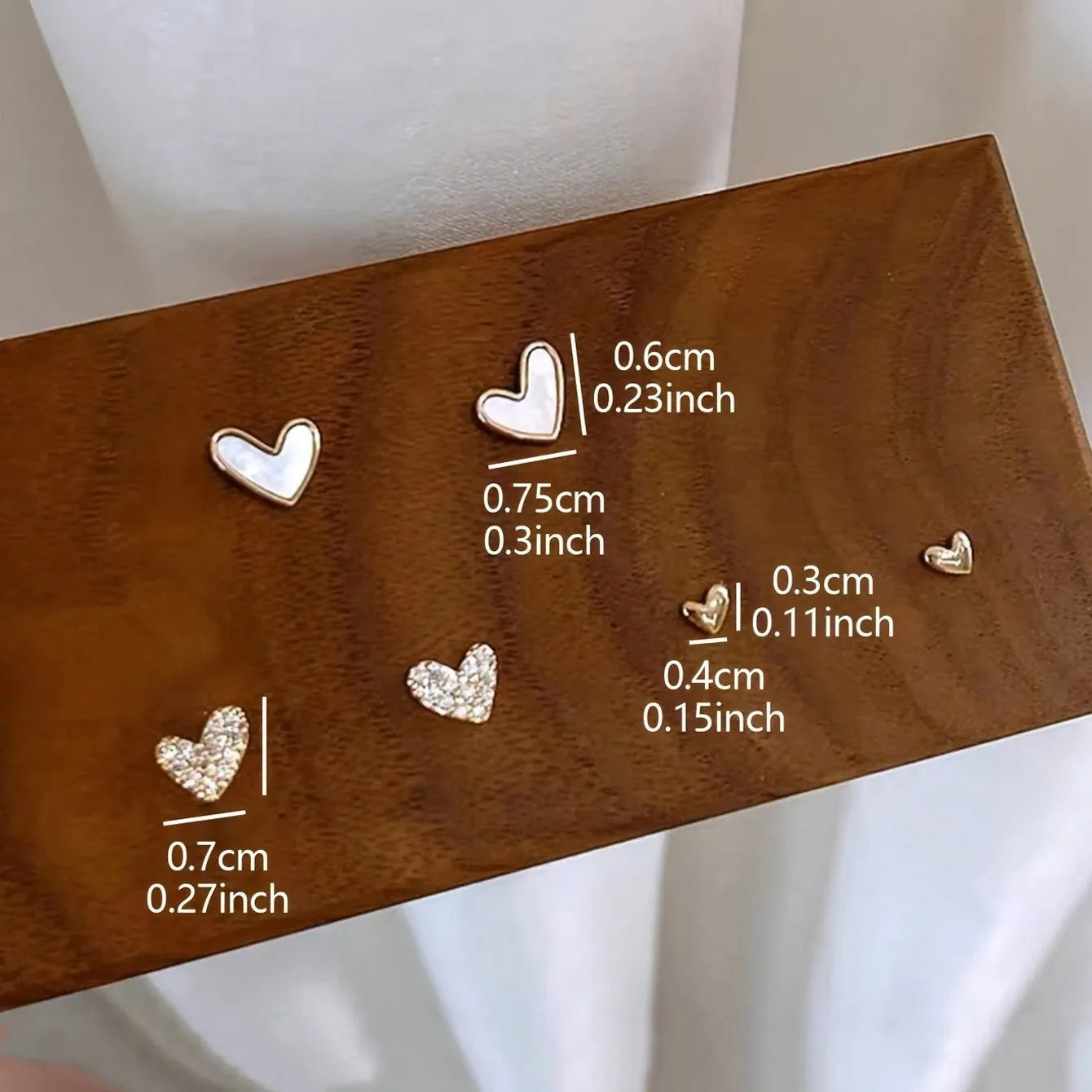 Women's three-pair heart-shaped love earrings set in gold, black, and pink colours with sweet girly style